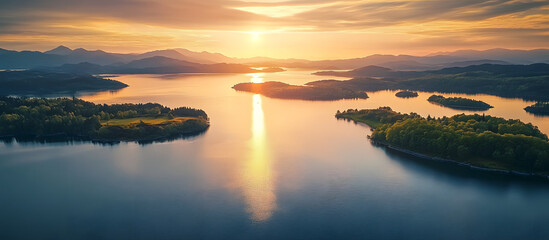 Wall Mural - Aerial drone shot of a serene lake coast at sunset with islands and a clear view ahead ideal for use as a copy space image