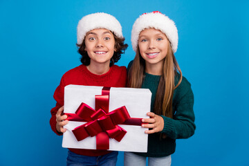 Wall Mural - Photo of two kids girl boy hold gift box package isolated blue color background