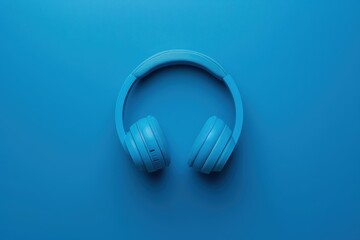 Bright blue headphones resting on a vibrant blue surface, showcasing a minimalist and modern design in a serene atmosphere