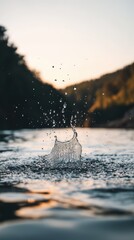 Pristine lake water splash at sunset