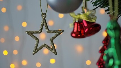 Wall Mural - Christmas tree decorated with golden star on pine branches with bokeh light background