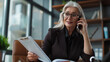 © Photolife   - Smiling Businesswoman Talking On Phone In Office