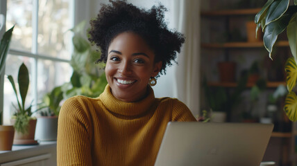 A happy African American woman engaged in a video call with diverse team members on a computer screen