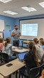 © Kitta - A teacher engaging students in a classroom discussion using a projector and interactive teaching methods.