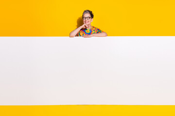 Canvas Print - Portrait of nice aged lady behind empty space placard wear t-shirt isolated on yellow color background