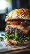© Kitta - Delicious hamburger with melted cheese, fresh lettuce, tomatoes, and pickles served on a toasted bun for a mouthwatering treat.