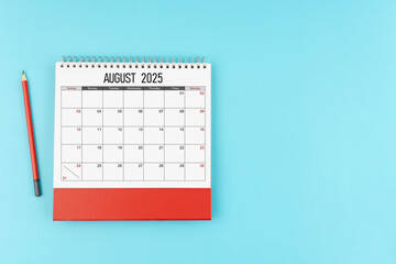 Wall Mural - August desk calendar for 2025 year with pencil on blue background, Position with copy space.