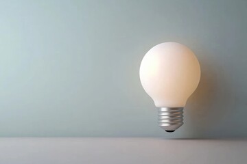 Wall Mural - A glowing light bulb against a minimalist background, symbolizing innovation, ideas, and creativity. Perfect for modern design and inspiration.