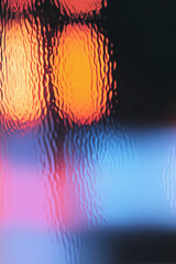 Poster - A vibrant abstract background featuring blurred colorful lights through a textured glass surface, creating a warm and inviting atmosphere.
