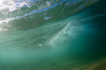 Underwater view below a small wave.