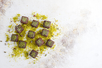 Handmade chocolate with pistachios, dark and milk chocolate pieces.