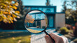 © Ruslan - Male realtor using magnifying glass to examine new house for sale or rent