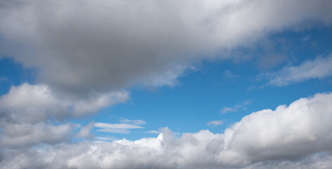 Wall Mural - blue gap in a grey cloud scape, natural background