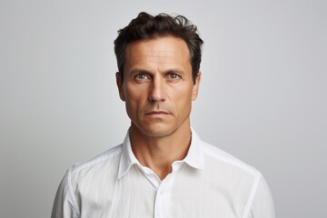 Poster - Portrait of a tender man in his 40s wearing a simple cotton shirt isolated on white background