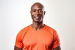 © Markus Schröder - Portrait of a tender afro-american man in his 40s wearing a moisture-wicking running shirt over white background