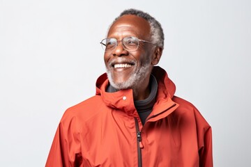 Poster - Portrait of a joyful afro-american man in his 70s wearing a windproof softshell in white background