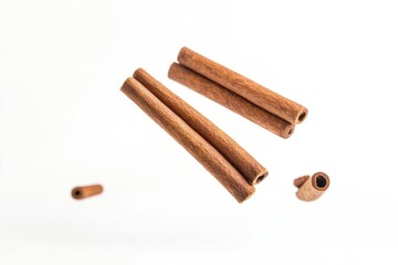 Poster - A pair of cinnamon sticks placed on a clean, white surface