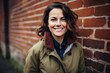 © Markus Schröder - Portrait of a grinning woman in her 40s sporting a breathable hiking shirt isolated in vintage brick wall