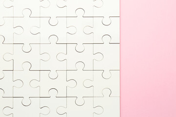 Wall Mural - White puzzle on pink background, top view