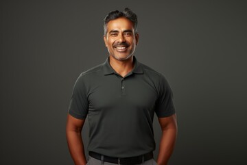 Wall Mural - Portrait of a happy indian man in his 40s wearing a breathable golf polo on modern minimalist interior