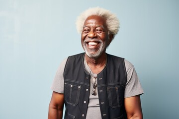 Wall Mural - Portrait of a happy afro-american man in his 70s dressed in a breathable mesh vest while standing against modern minimalist interior