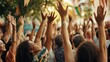 © Johannes - Diverse group of individuals raising their hands in a cultural event or festival showcasing unity and celebration