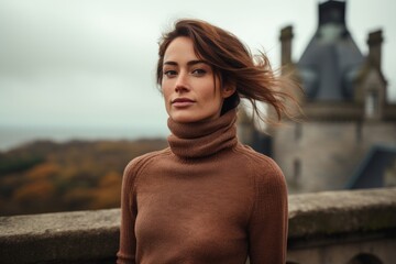 Canvas Print - Portrait of a tender woman in her 30s wearing a classic turtleneck sweater isolated in historic castle backdrop