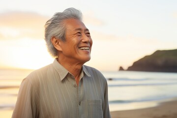 Wall Mural - Portrait of a blissful asian elderly man in his 90s donning a trendy cropped top isolated in beautiful beach sunset