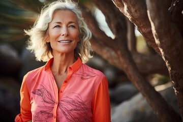 Wall Mural - Portrait of a merry woman in her 50s sporting a breathable hiking shirt isolated on vibrant coral reef