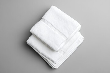 Poster - A collection of white towels stacked on a table, ideal for use in various settings such as bathrooms or kitchens