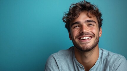 Wall Mural - Portrait of a happy handsome man in a shirt with laughing