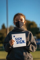 Canvas Print - A young girl wearing a face mask holds up a colorful sign, possibly for a protest or awareness campaign