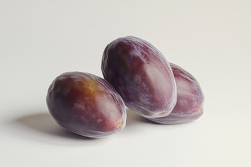 Poster - A pair of plums sit on a table, fresh and ripe