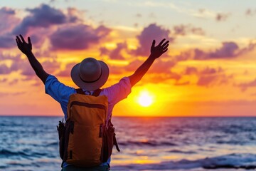 Wall Mural - A person standing on the beach wearing a hat and backpack, great for outdoor adventure or travel themes