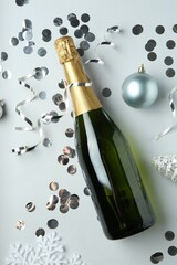 Sticker - Flat lay composition with bottle of sparkling wine, shiny confetti and other Christmas decor on light grey background