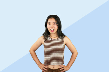 Excited Asian Student Girl gives expression hand fa gesture of sad, wow, happy, laughing in blue background