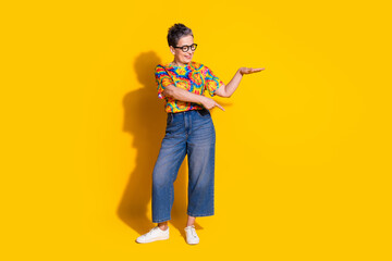 Wall Mural - Photo of lovely charming nice woman wear trendy clothes look empty space isolated on yellow color background