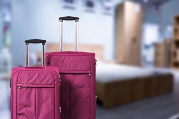 Modern travel Suitcase near bed in hotel room