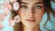 © Arifin Studio - A close-up portrait of a young woman with pink rose petals falling around her face. Her eyes are wide and her expression is soft and gentle.
