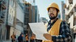 © Валерий Тодаренко - An Asian male construction worker with a beard, holding a blueprint and directing a team on a building site.