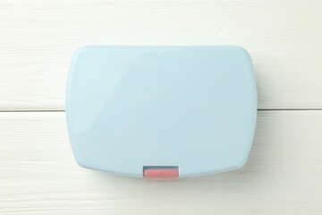 Wall Mural - Light blue lunch box on white wooden table, top view