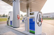 © Raivo - A modern gas station with fuel pumps and a fire extinguisher on the pillar, featuring a clean, spacious layout and contemporary design.