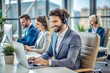 © Laymanzoom - callcenter operator with headphones sitting at modern office with collegues