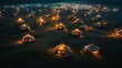 © DIAHIMAGESNEW - An aerial view of a camp of traditional yurts lit up at night.