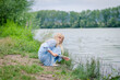 © katarinagondova - girl with long blond hair outdoors by the river alone