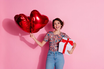 Poster - Photo of cheerful lovely girl wear trendy clothes hold gift celebrate holiday isolated on pink color background