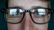 © LifeStock - Close-Up of Eyeglasses Reflecting Code, Symbolizing Technology and Focus