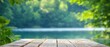 © Viktor - A crisp image of a wooden table against a softly blurred backdrop of trees and a tranquil waterbody in the foreground