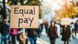 © Anna - Equal pay, protest with women holding signs demanding wage equality, illustrating the ongoing struggle against gender discrimination in salaries