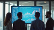 © Vasilina FC - Business team analyzing financial data on large screen